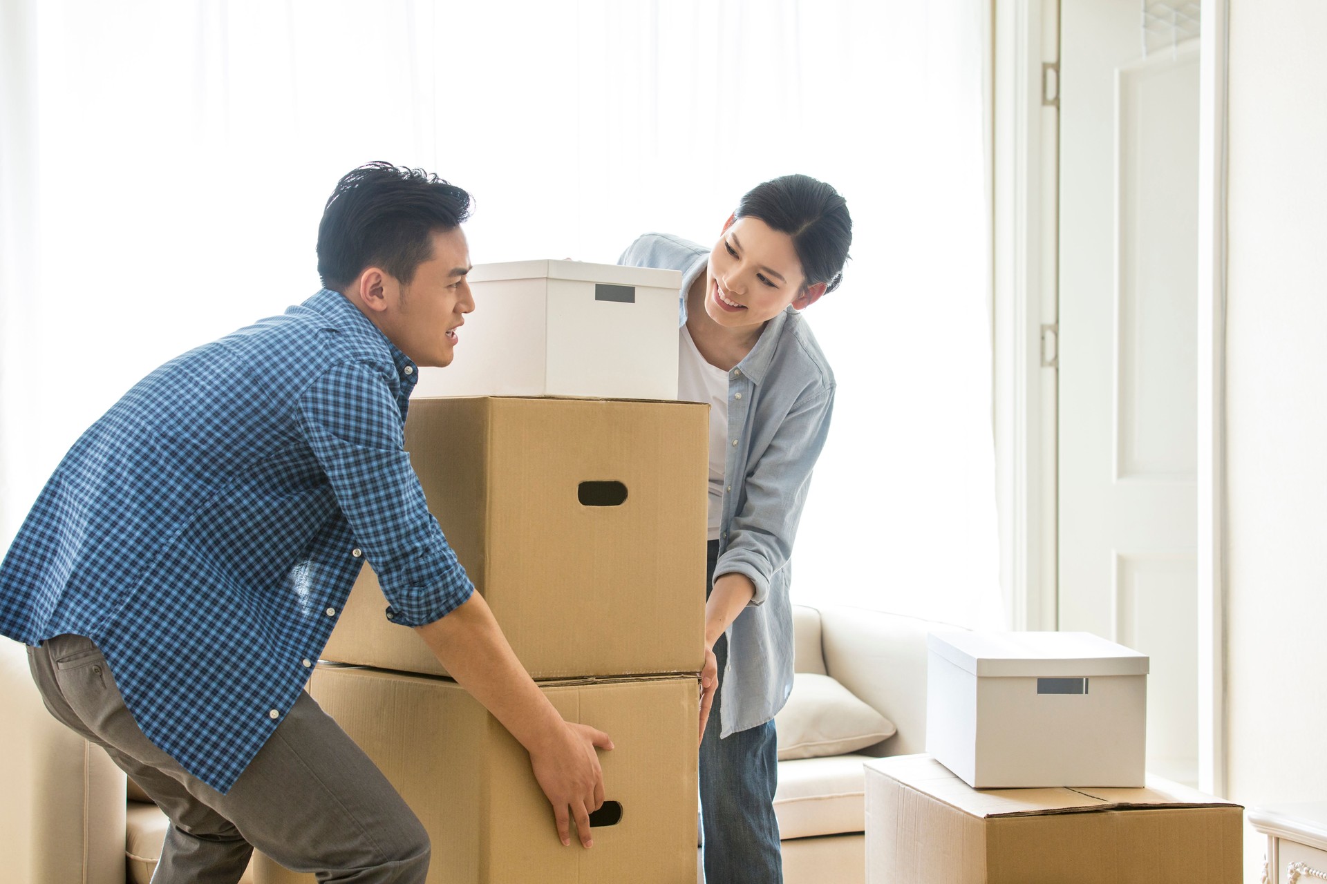 Young couple moving together collaboratively, Japanese style moving - stock photo